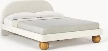 Čalouněná postel's kulovými nohami z